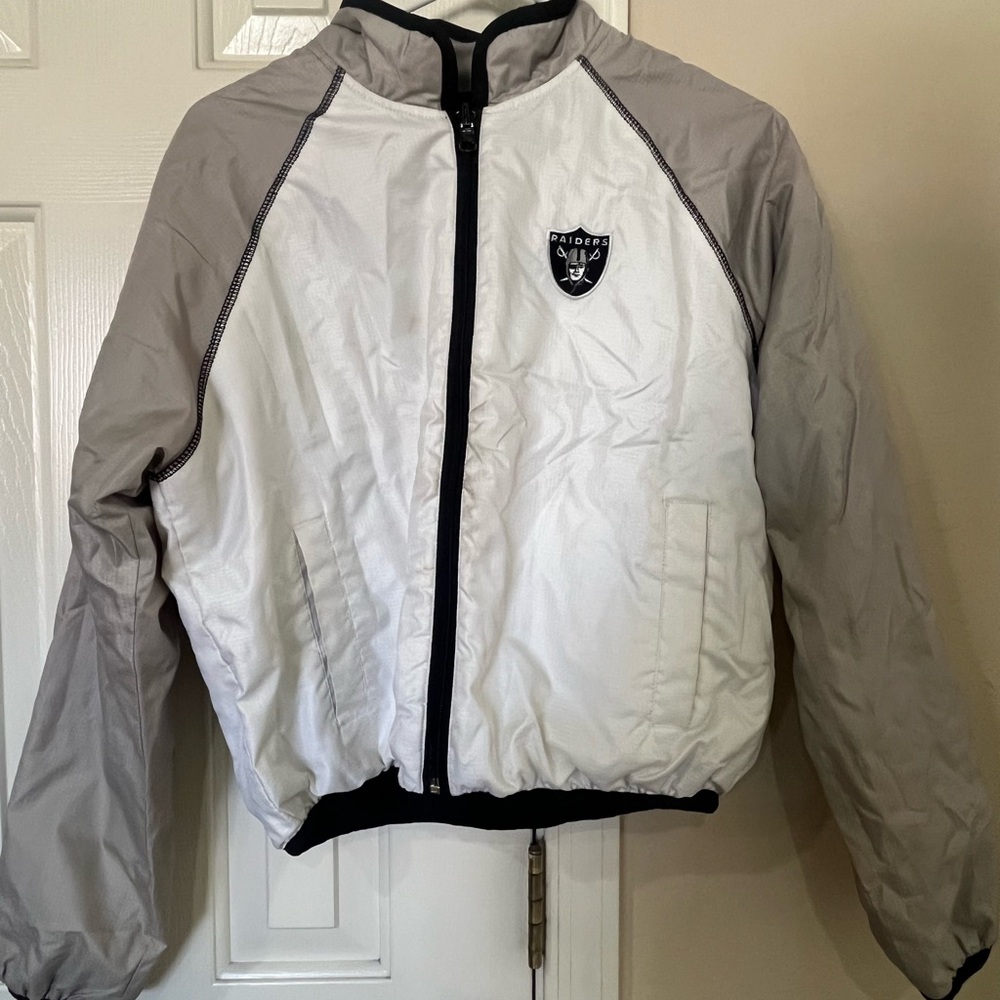 White and grey Oakland Raiders windbreaker jacket.